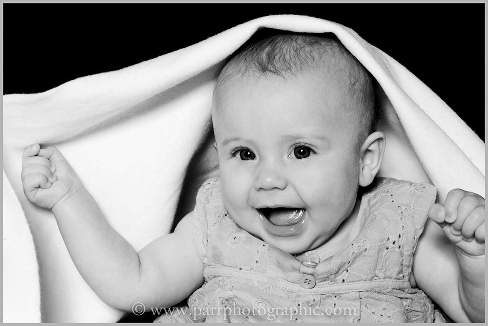 Studio Portrait of a baby under a towel