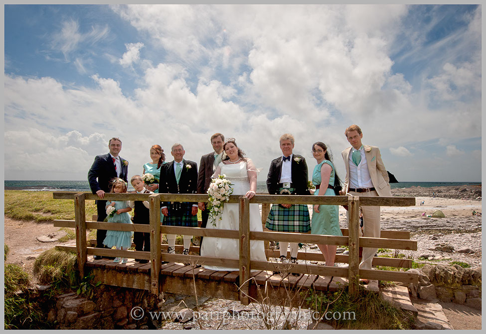 Wedding party on a bridge on Wembury beach Devon